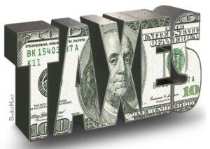 The word taxes with dollar bill background