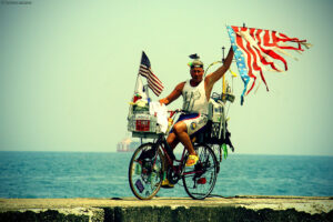 man on bike with flags