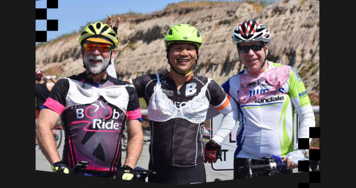 Three cyclists wearing bras over their jerseys