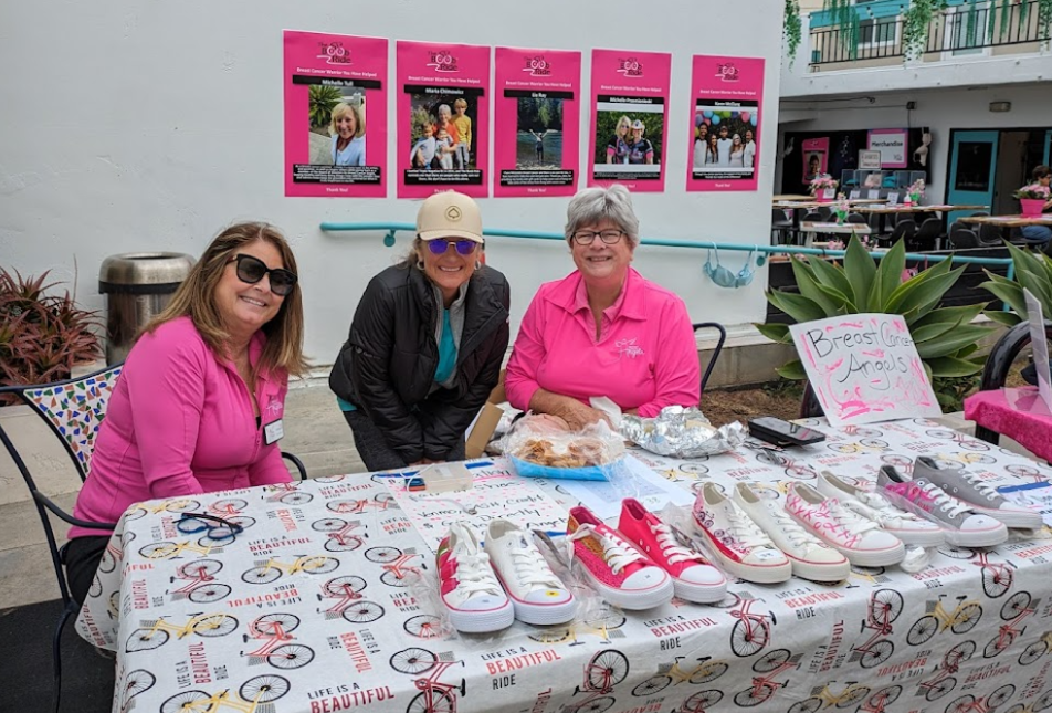 Volunteers sitting at a table at an event