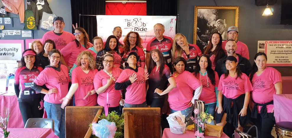 People in pink shirts volunteering at a party